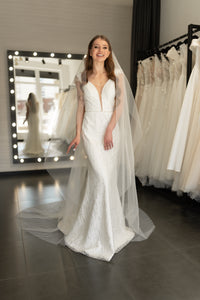 Bride wearing angel cut ivory wedding veil with flowing tulle