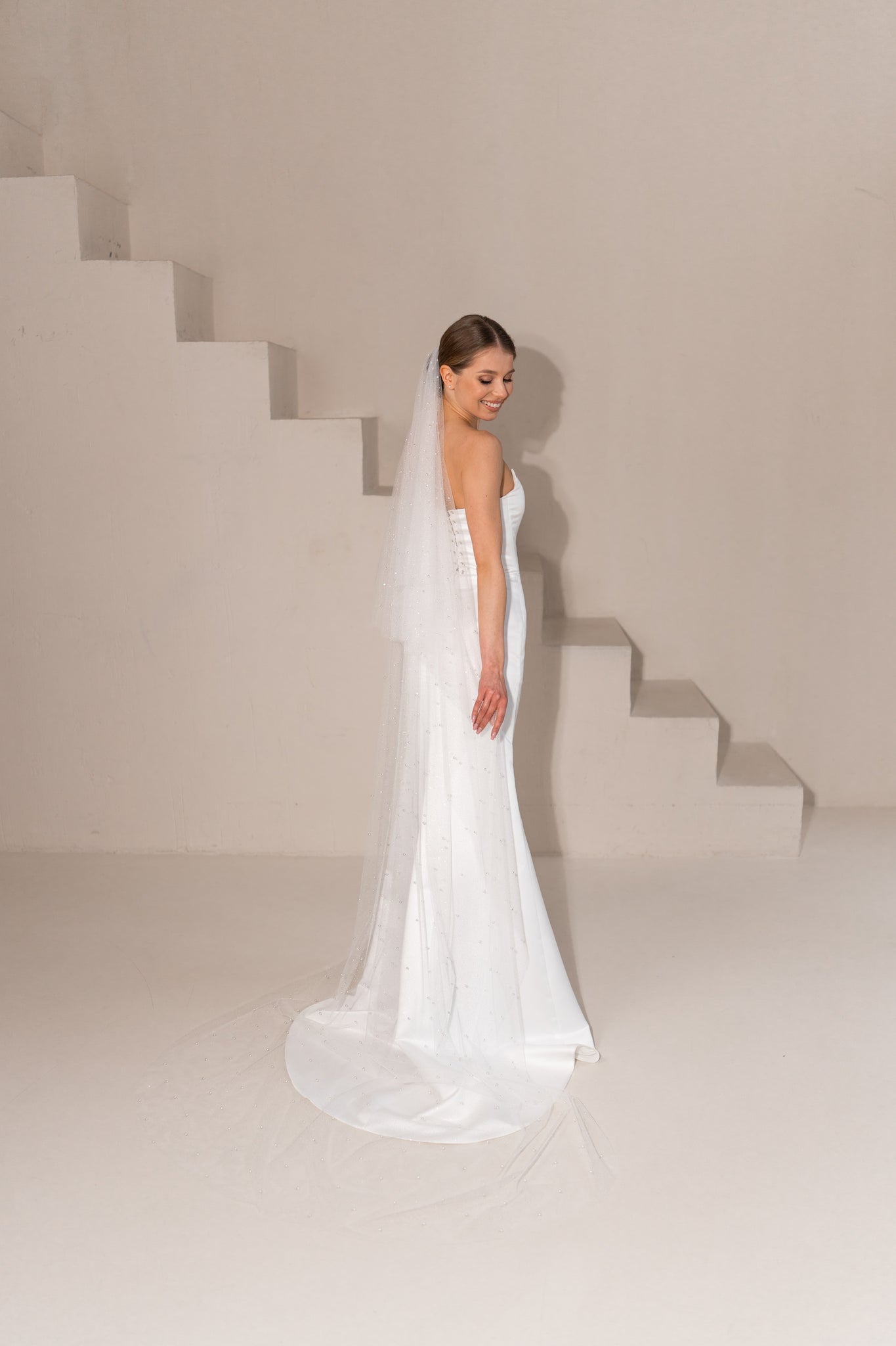 Radiant sparkle and pearl accents on long bridal veil