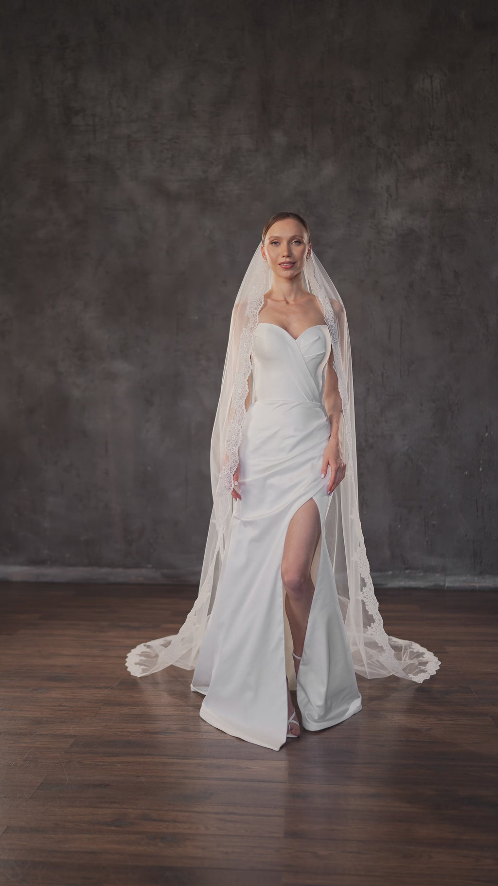 Cathedral length bridal veil with embroidered lace edge and metal comb.