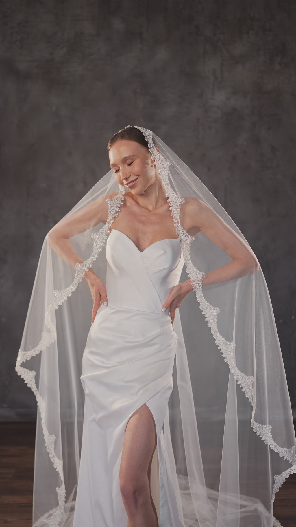 Bride wearing a cathedral Spanish mantilla veil with embroidered floral lace edge.